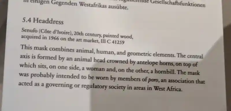 Description of Senufo headdress mask, woman, animal, and crucifix-like symbol, located in Bode Museum